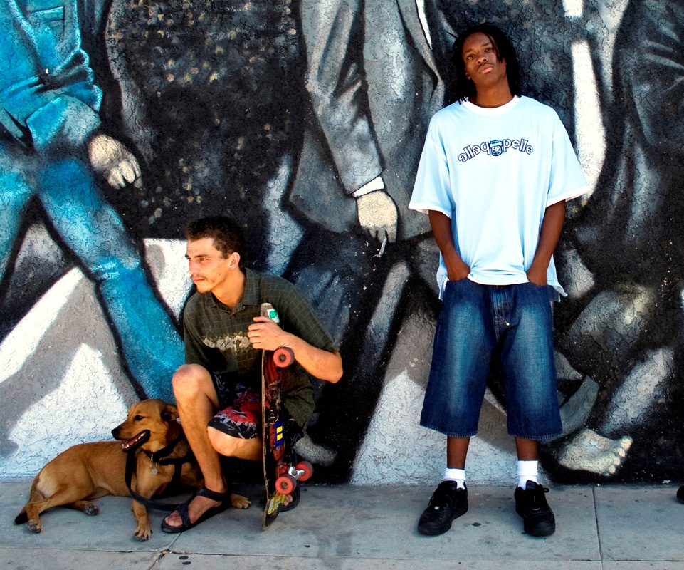 Youth people in street with grafiti behind